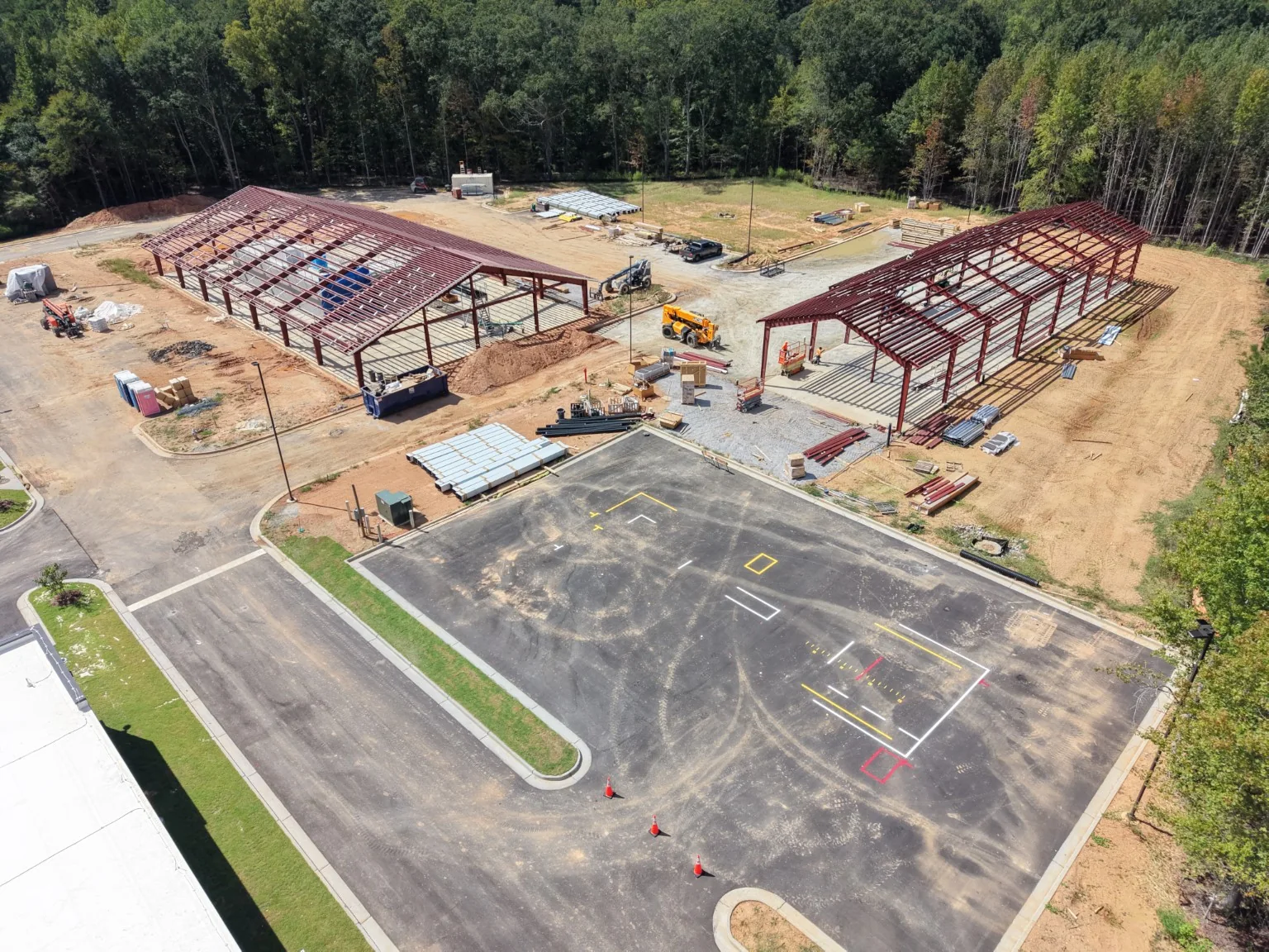 Aerial view of two steel structures and adjacent parking